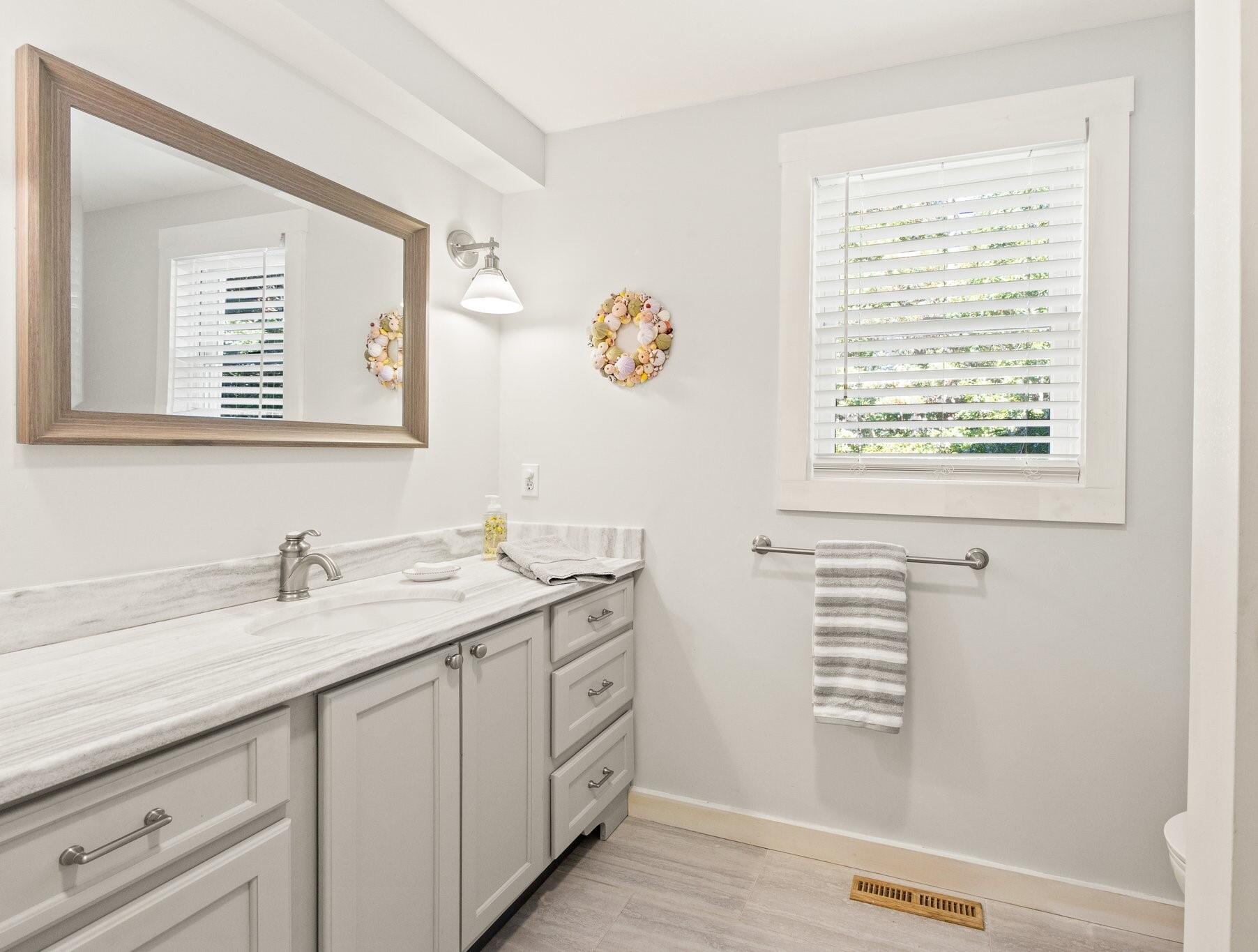 49 River Ridge Road Marstons Mills, MA 02648 - Photo 15 of 37 a bathroom with a sink a vanity and a window