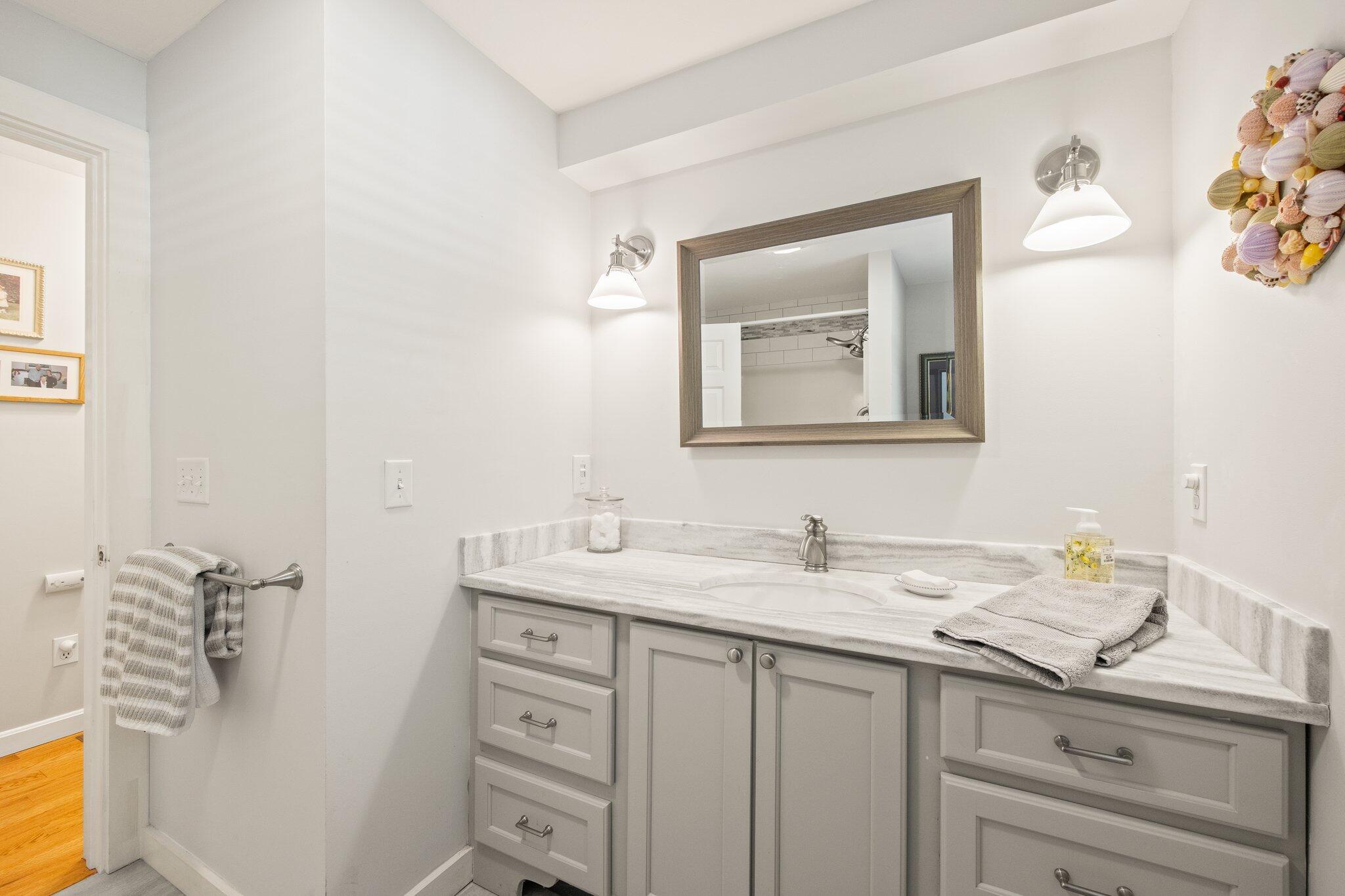 49 River Ridge Road Marstons Mills, MA 02648 - Photo 16 of 37 a bathroom with a sink and a mirror