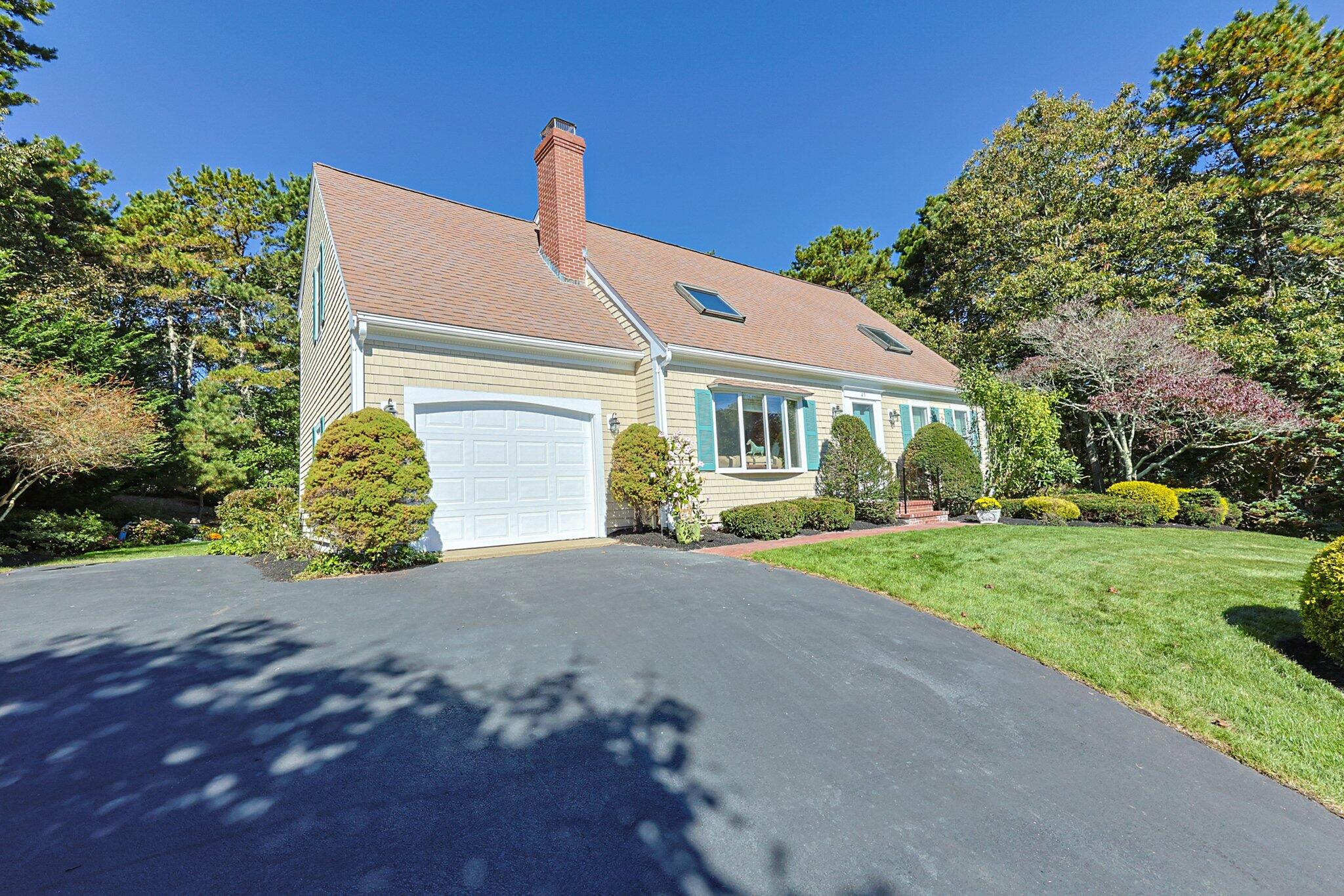 49 River Ridge Road Marstons Mills, MA 02648 - Photo 3 of 37 a front view of a house with a yard and garage