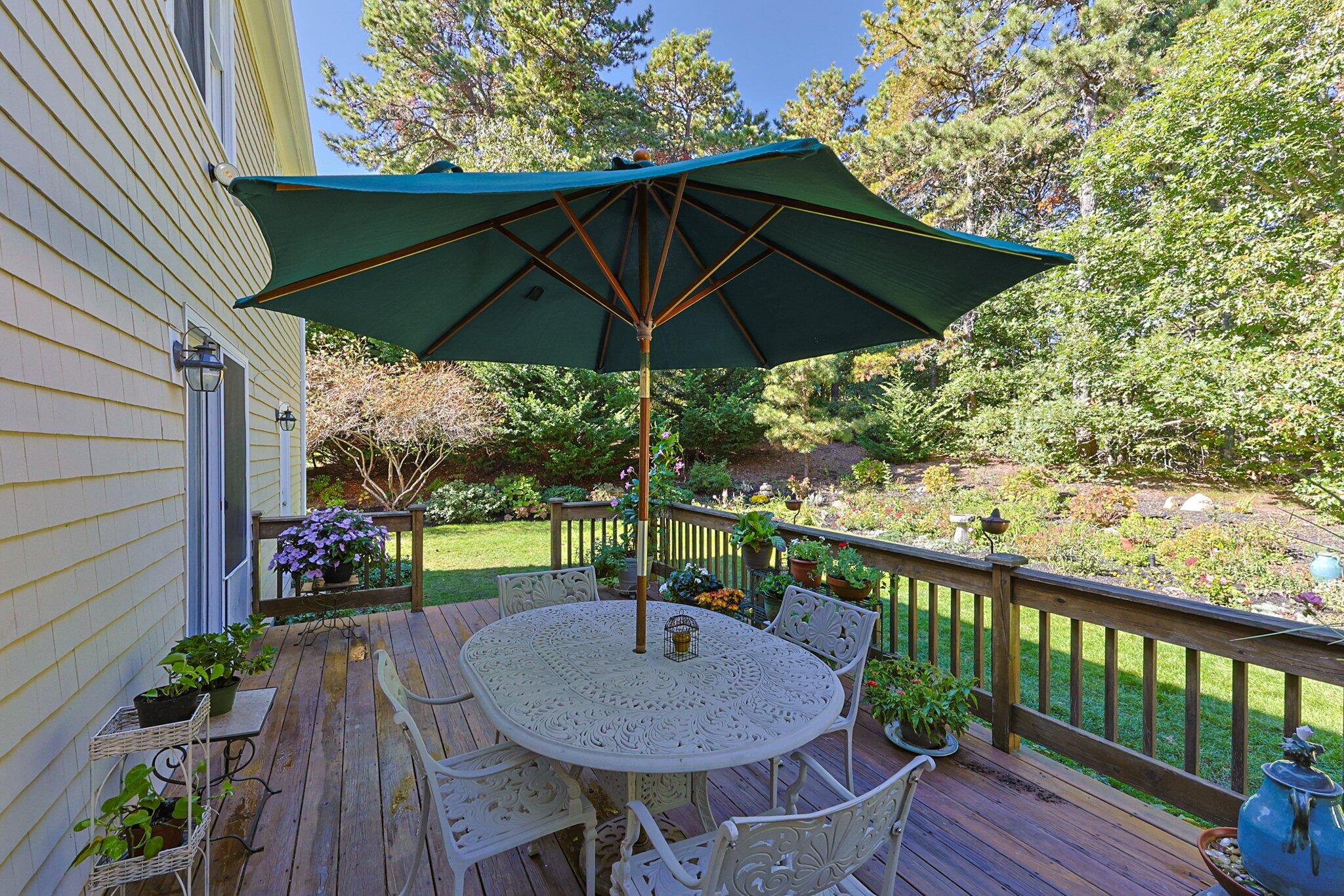 49 River Ridge Road Marstons Mills, MA 02648 - Photo 32 of 37 a view of a outdoor sitting area with furniture and umbrella