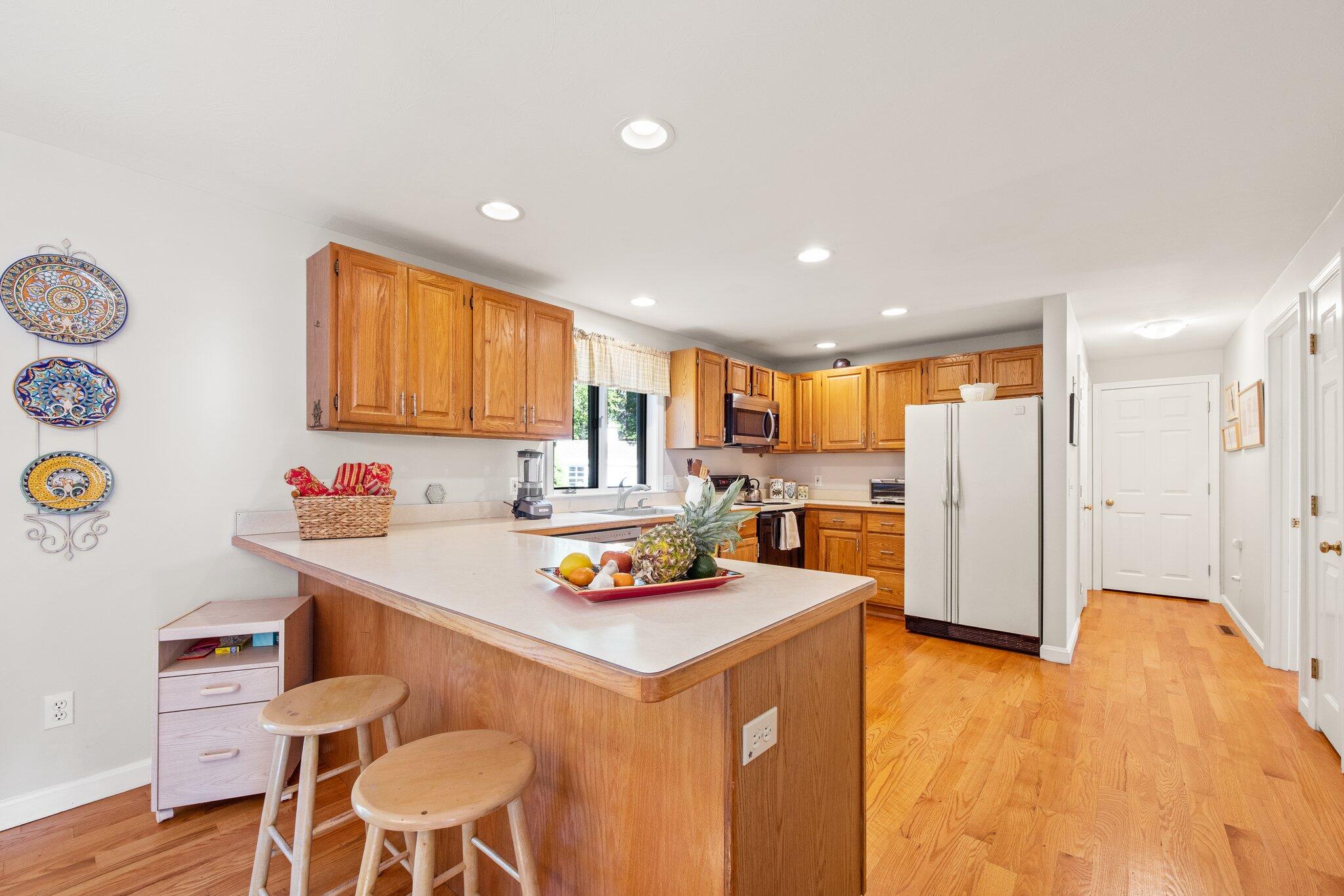 49 River Ridge Road Marstons Mills, MA 02648 - Photo 10 of 37 a living room with stainless steel appliances furniture a rug and a kitchen view