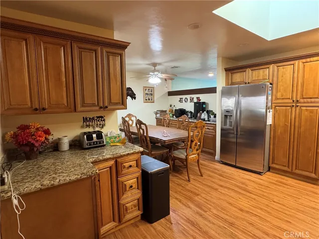 a kitchen with stainless steel appliances granite countertop a stove top oven a refrigerator and island