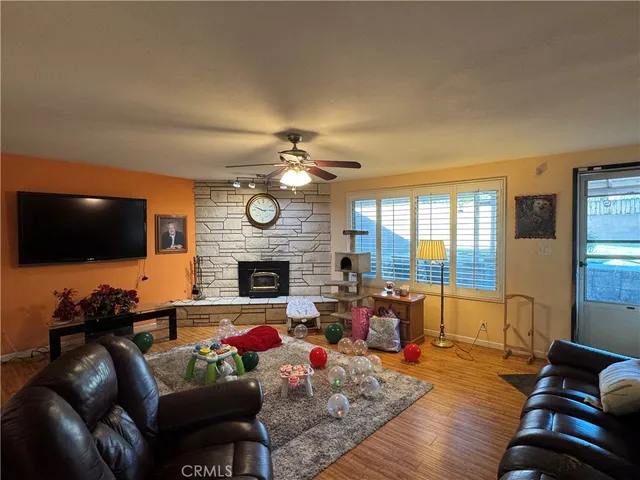 a living room with furniture a flat screen tv and a fireplace