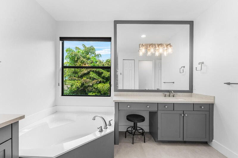 8091 Snowflake Obsidian Trail Delray Beach, FL 33446 - Photo 28 of 35 a bathroom with a tub sink and mirror