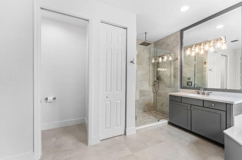 8091 Snowflake Obsidian Trail Delray Beach, FL 33446 - Photo 29 of 35 a bathroom with a double vanity sink mirror and shower
