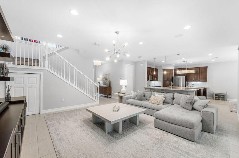 8091 Snowflake Obsidian Trail Delray Beach, FL 33446 - Photo 7 of 35 a living room with furniture and a chandelier