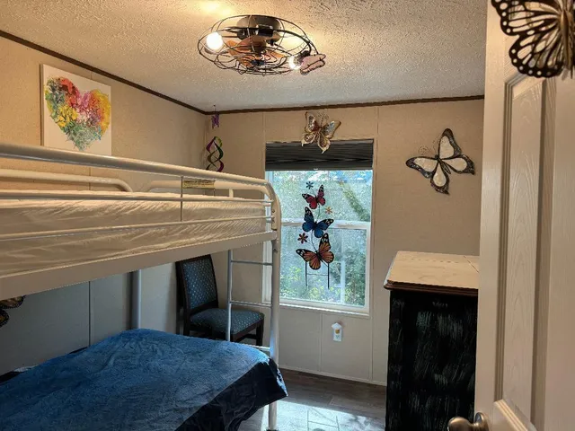 a view of a hallway with a dining table and chairs