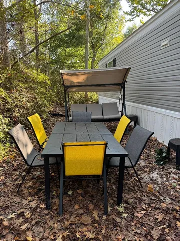 a view of a chairs and table in a backyard