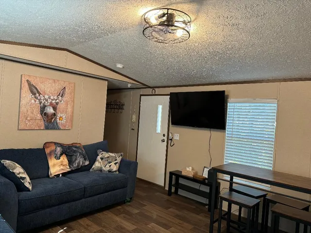 a living room with furniture and a flat screen tv