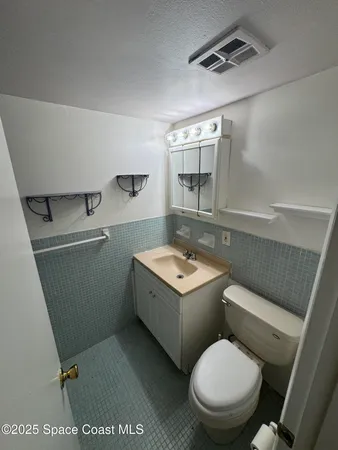a bath tub sitting next to a white sink and toilet