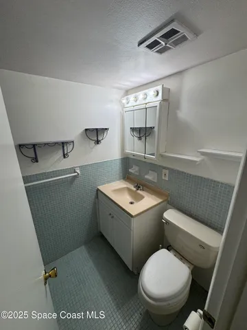 a bath tub sitting next to a white sink and toilet