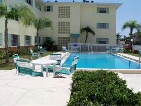 a view of a house with swimming pool and sitting area