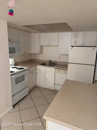 a kitchen with cabinets and white appliances