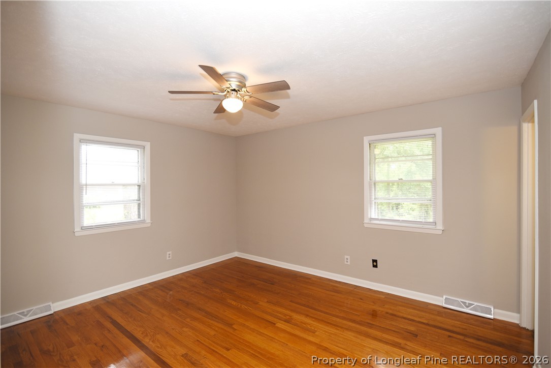 1673 Norment Road Lumberton, NC 28360 - Photo 16 of 32 a view of empty room with wooden floor and fan