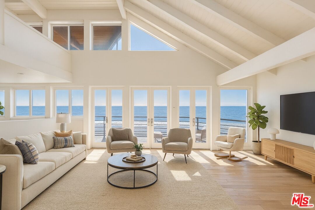 25266 Malibu Road Malibu, CA 90265 - Photo 12 of 15 a living room with furniture and a flat screen tv
