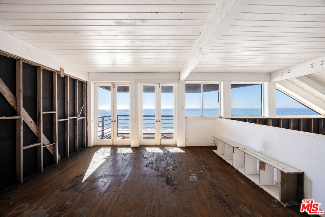 25266 Malibu Road Malibu, CA 90265 - Photo 7 of 15 wooden floor in an empty room with wooden floor and a window