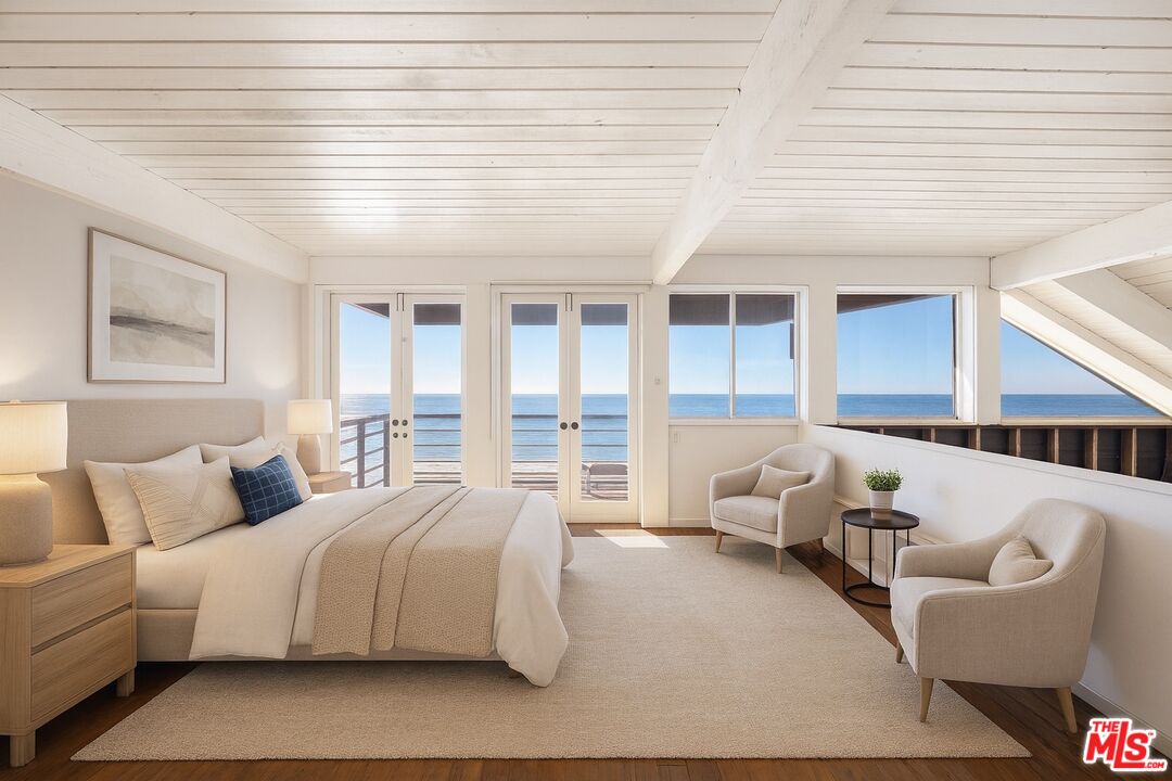 25266 Malibu Road Malibu, CA 90265 - Photo 8 of 15 a spacious bedroom with a bed and glass windows