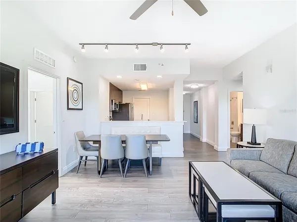 a large bed sitting in a bedroom next to a lamp