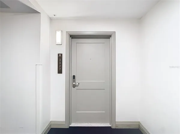 a view of hallway with wooden floor