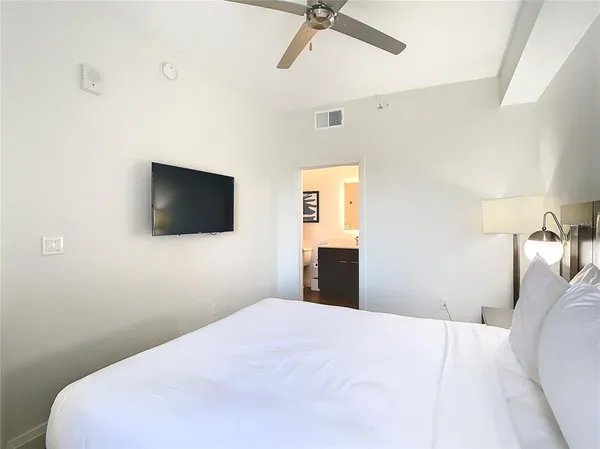 a view of a swimming pool with a lawn chairs and plants