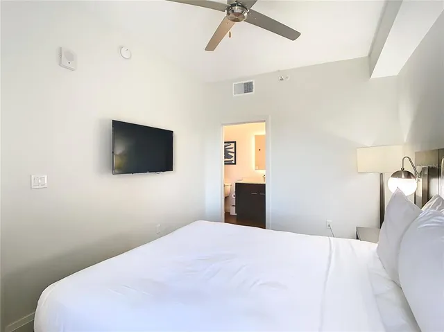 a view of a swimming pool with a lawn chairs and plants