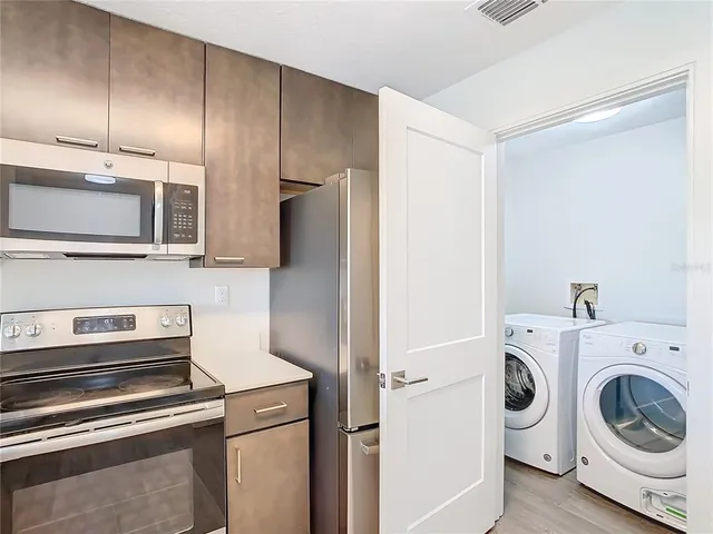 a kitchen with a refrigerator stove and microwave
