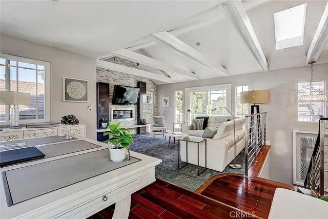 a living room with fireplace furniture and a potted plant