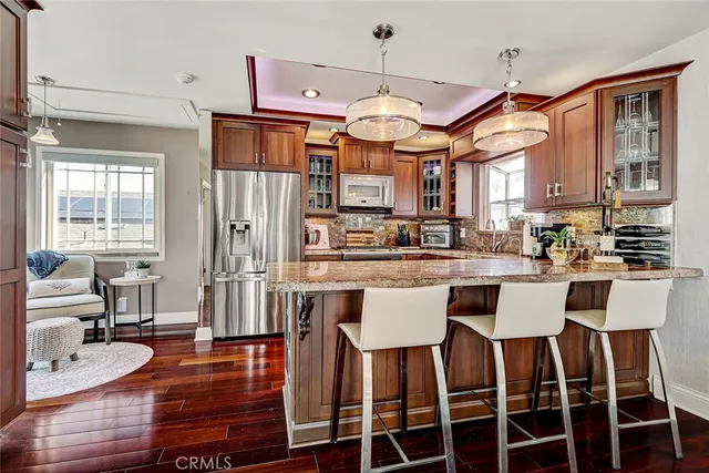a large kitchen with a table and chairs