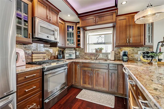 a kitchen with stainless steel appliances granite countertop a stove and a sink