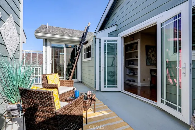 a outdoor space with the couches and dining table with the balcony view