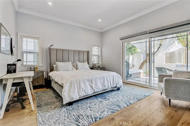 a bedroom with a large bed and a large window