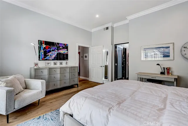 a bedroom with bed and a flat screen tv