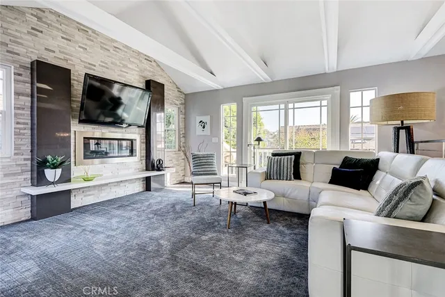a living room with furniture large window and flat screen tv
