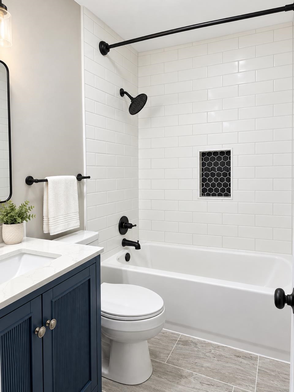 5085 Bowie Road Memphis, TN 38109 - Photo 6 of 8 White subway tile shower surround with a black hexagon tile niche