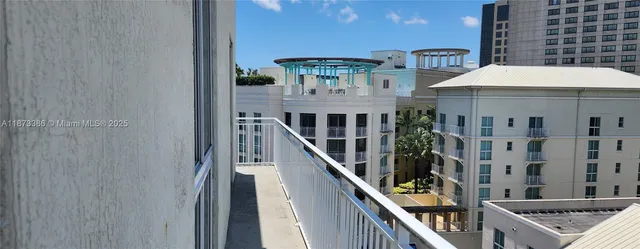 a view of balcony with lots of frames on wall and wooden floor