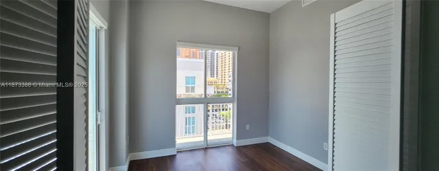 a view of an entryway with wooden floor