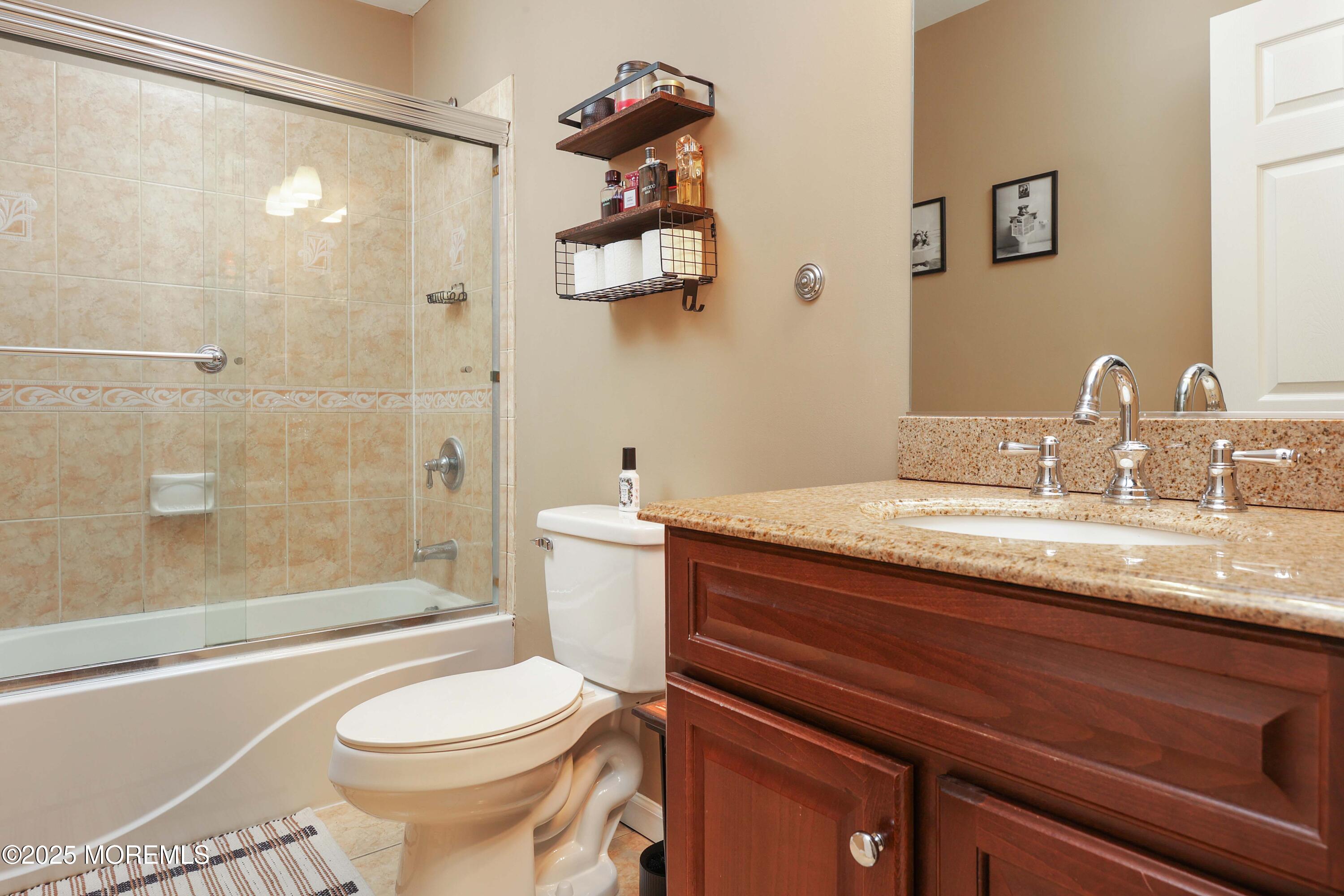 58 Richardson Avenue Eatontown, NJ 07724 - Photo 15 of 26 a bathroom with a granite countertop sink toilet and shower