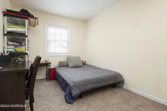 a bedroom with a bed chair and a window