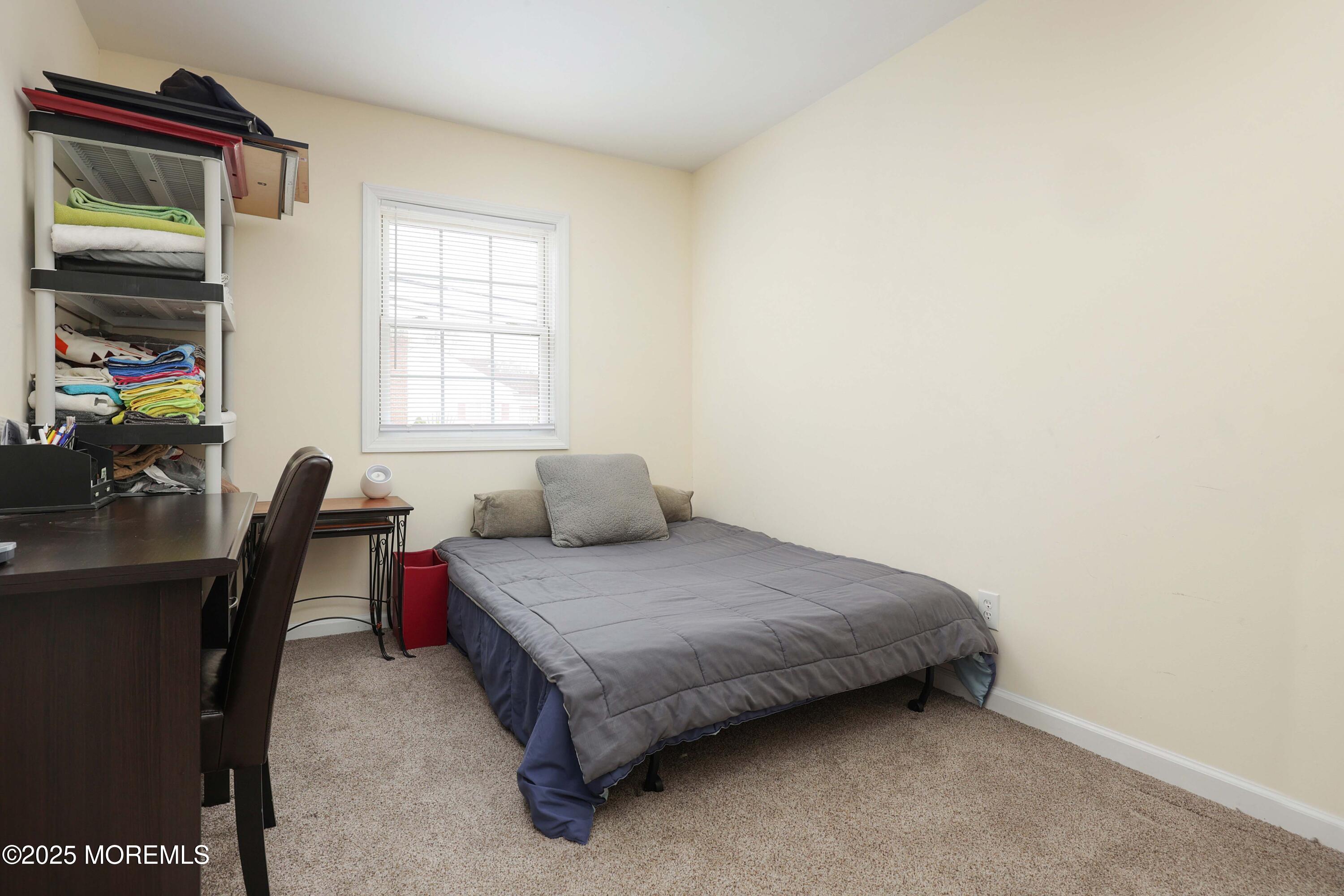 58 Richardson Avenue Eatontown, NJ 07724 - Photo 17 of 26 a bedroom with a bed chair and a window