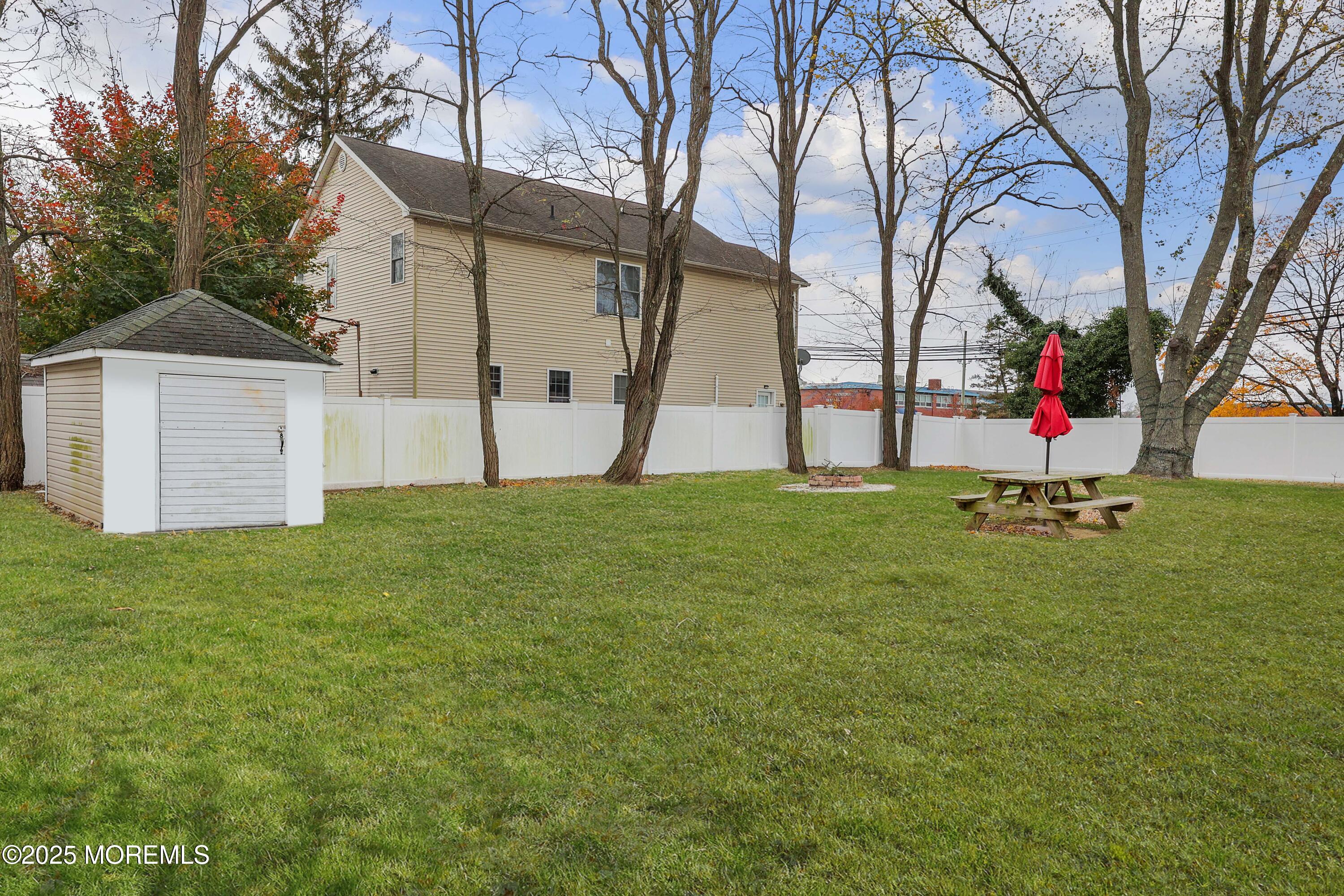 58 Richardson Avenue Eatontown, NJ 07724 - Photo 21 of 26 a view of a white house with a small yard and large tree
