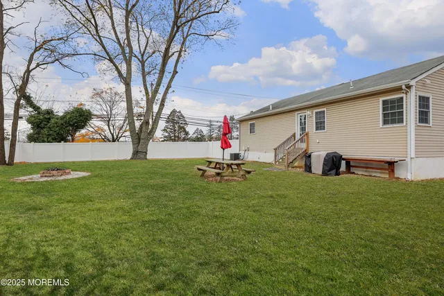 a backyard of a house with table and chairs