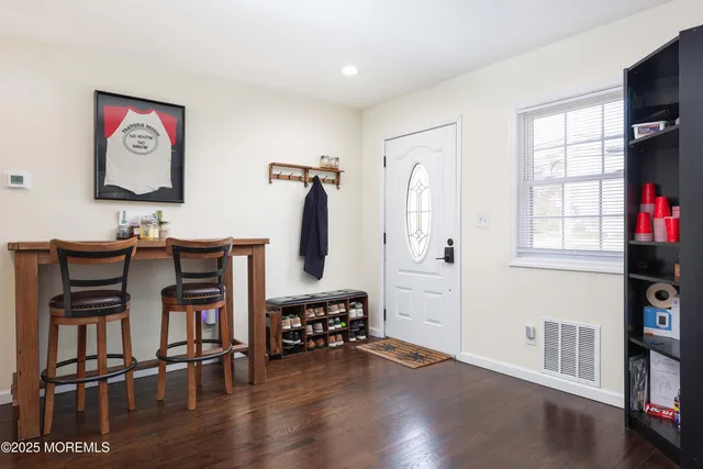 a workspace with furniture window and wooden floor
