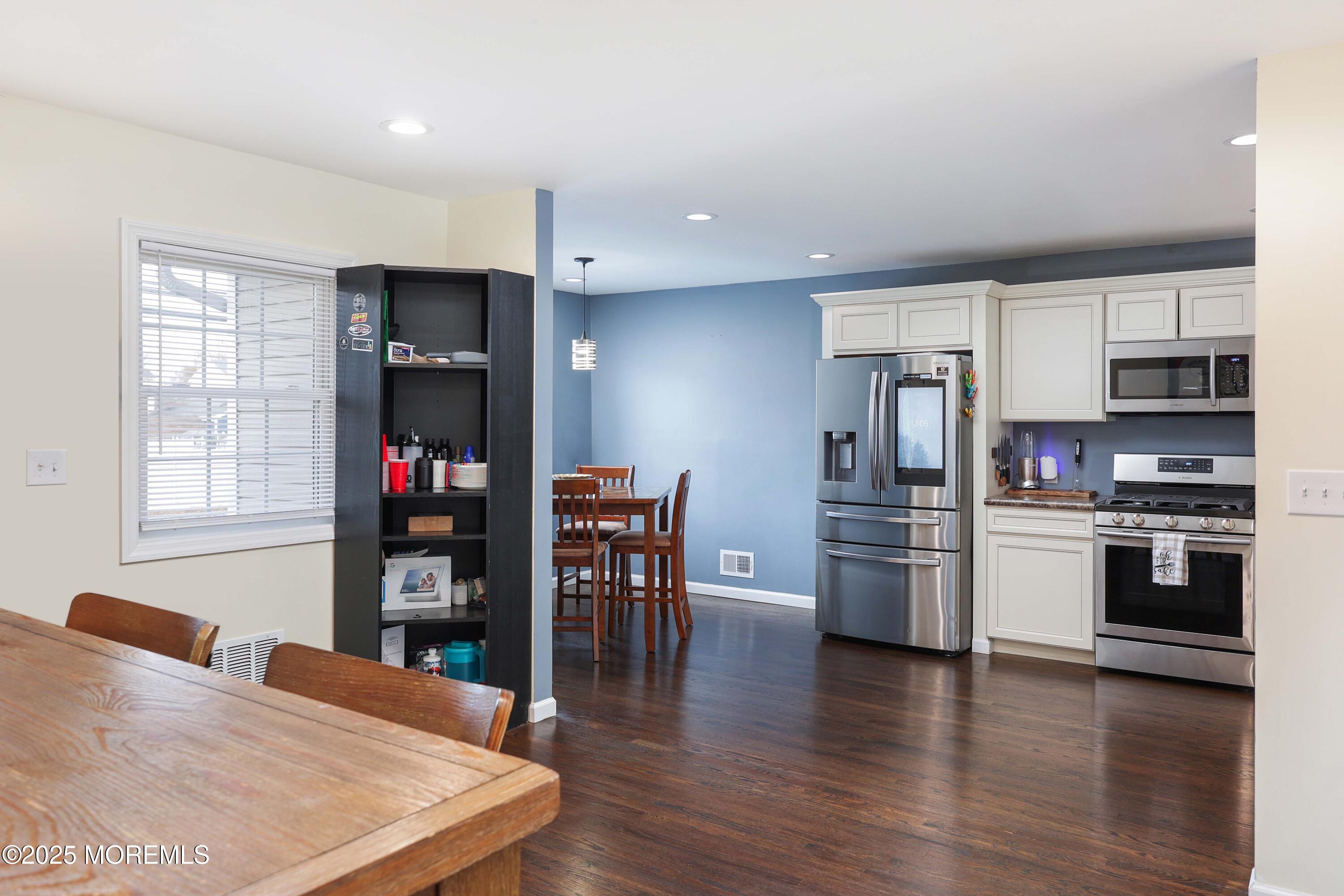 58 Richardson Avenue Eatontown, NJ 07724 - Photo 7 of 26 a kitchen with stainless steel appliances kitchen island granite countertop a refrigerator and stove top oven
