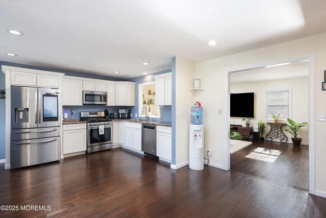 a kitchen with a refrigerator and a stove top oven