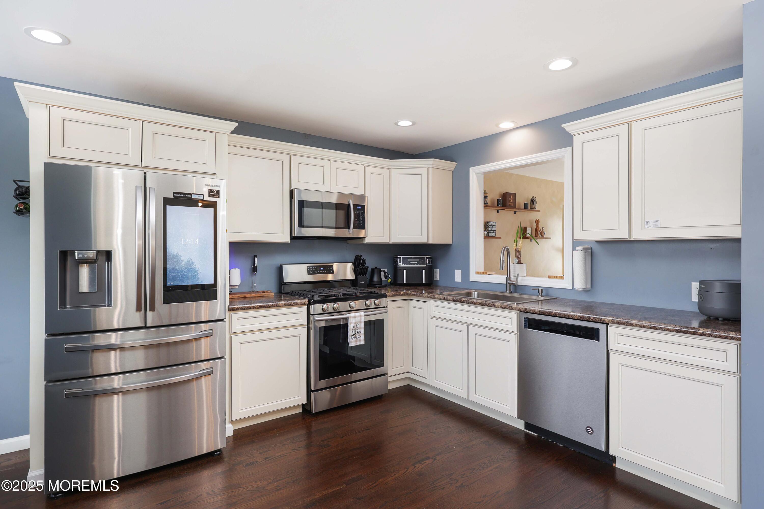 58 Richardson Avenue Eatontown, NJ 07724 - Photo 10 of 26 a kitchen with cabinets stainless steel appliances and wooden floor