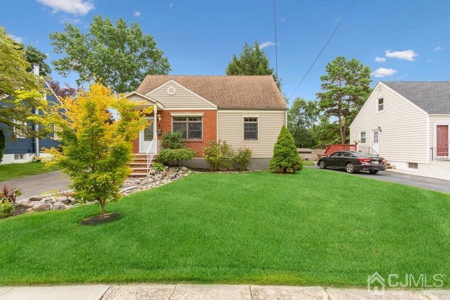 a front view of a house with garden