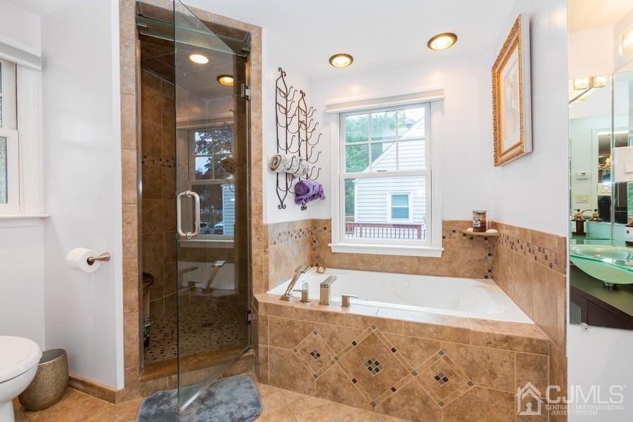 817 Dunellen Avenue Dunellen, NJ 08812 - Photo 12 of 20 a bath room with a bath tub and a shower