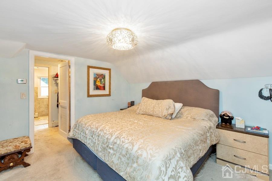 817 Dunellen Avenue Dunellen, NJ 08812 - Photo 14 of 20 a bedroom with a bed and a chandelier