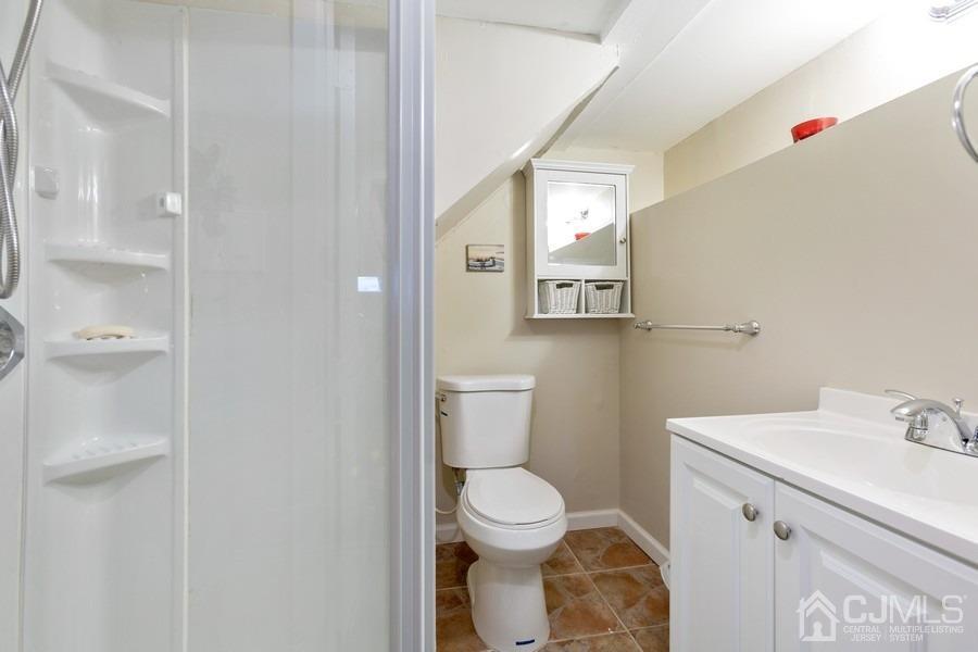 817 Dunellen Avenue Dunellen, NJ 08812 - Photo 16 of 20 a bathroom with a toilet sink and mirror