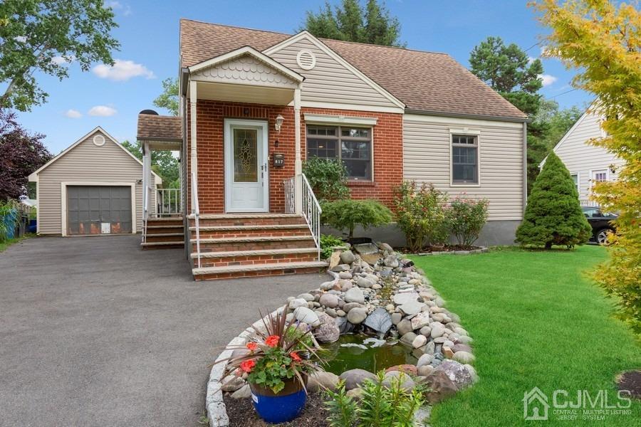 817 Dunellen Avenue Dunellen, NJ 08812 - Photo 3 of 20 a front view of a house with a garden
